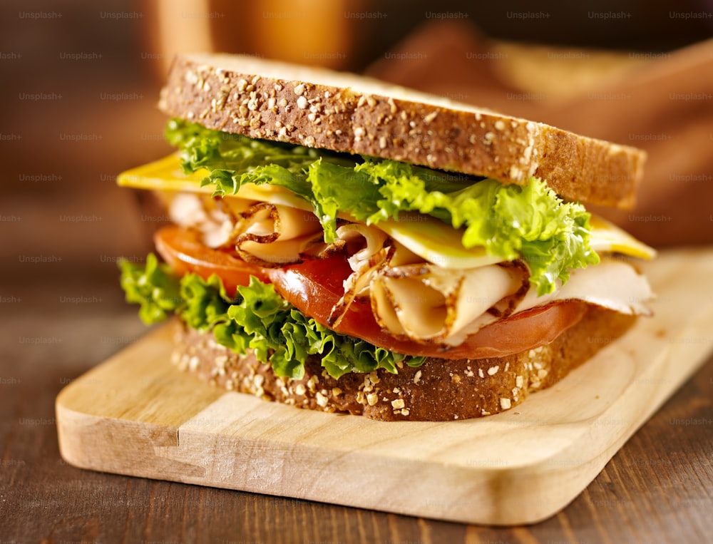 close up photo of a deli meat sandwich with turkey