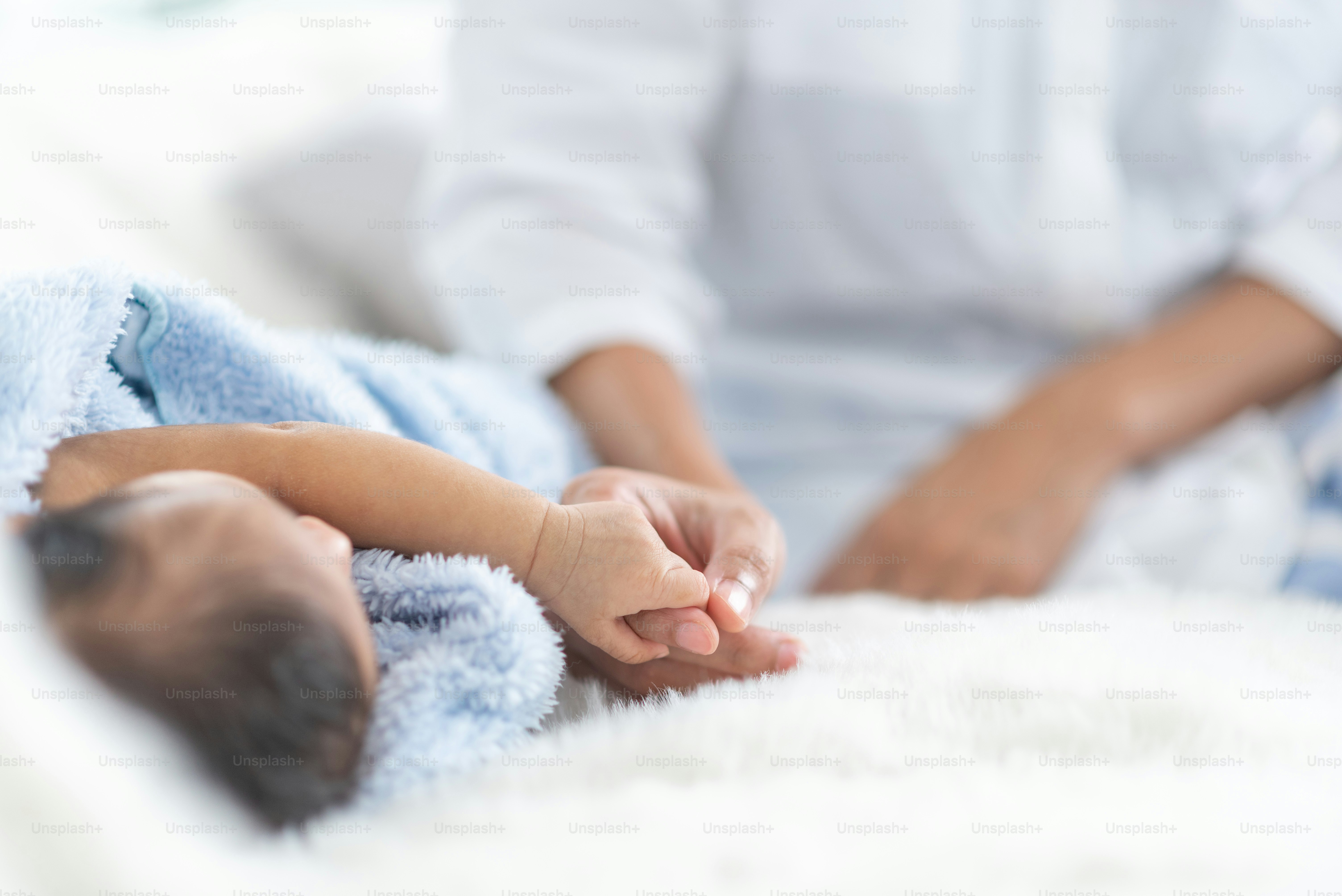 A young mother carries a baby