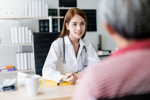smart and attractive asian woman doctor explain and discuss with old asian man for consult clinic background health concept