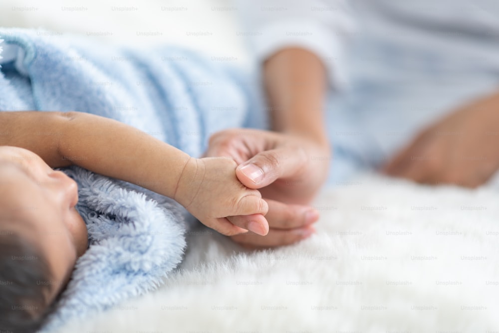 Newborn baby sleeping in bed