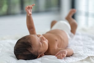 Newborn baby sleeping in bed