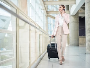Beautiful business woman is walking in Airport , Business travel concept