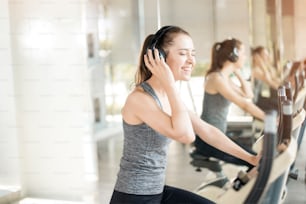 Pretty young sport woman is exercise on bicycle in gym, Healthy lifestyle