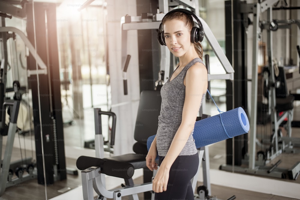 Pretty young sport woman is workout with mat  in gym, Healthy lifestyle