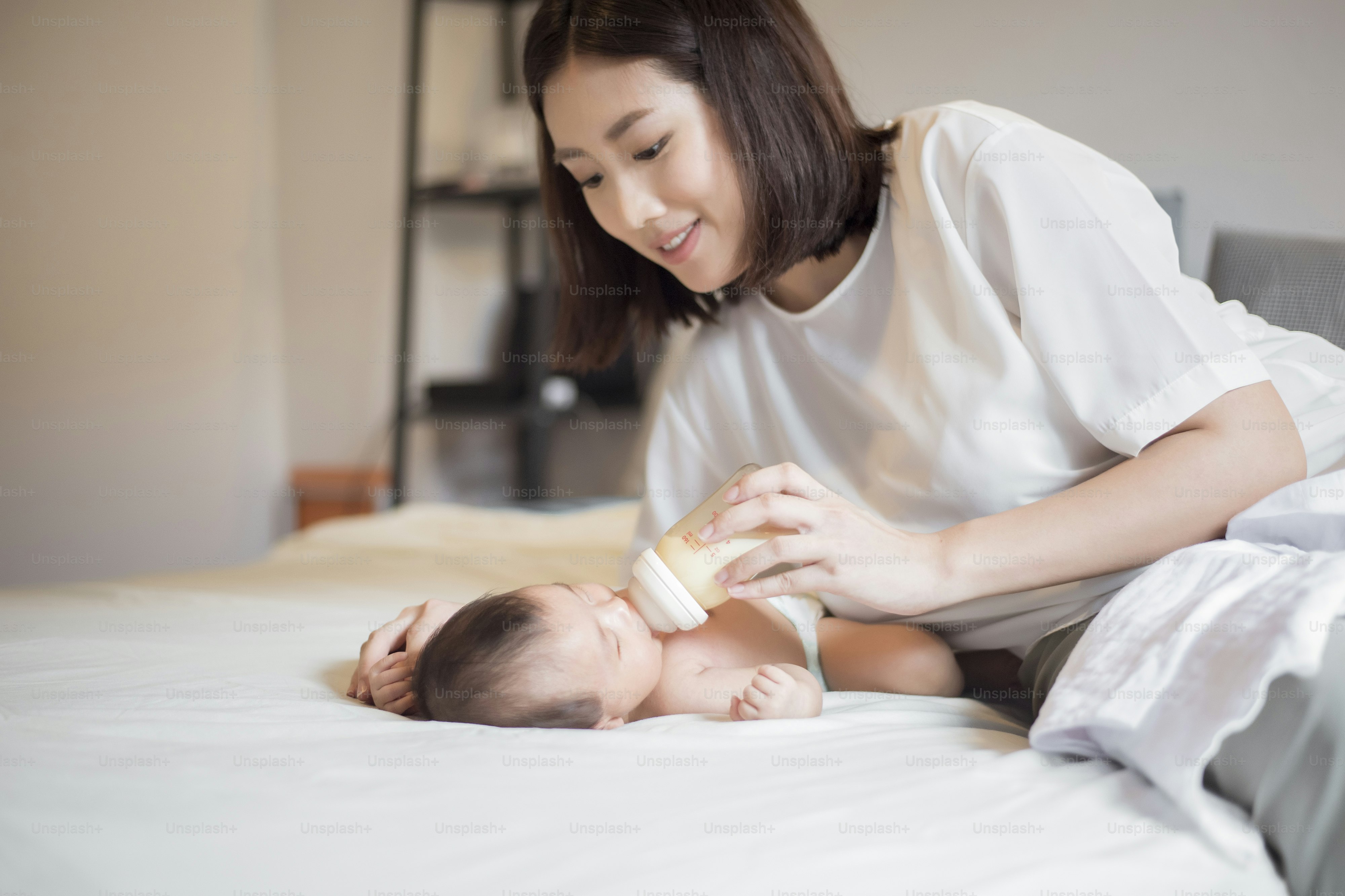 Newborn baby girl is drinking milk by  her mother