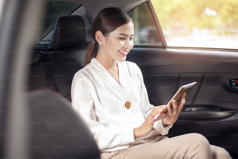 Beautiful business woman is working in car