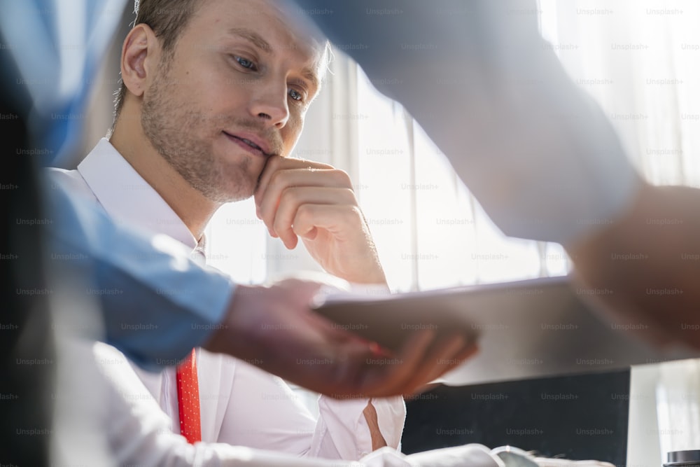 successful business meeting caucasian businessman manager white shirt red tie enjoy with result of profit from chart graph with co worker office background