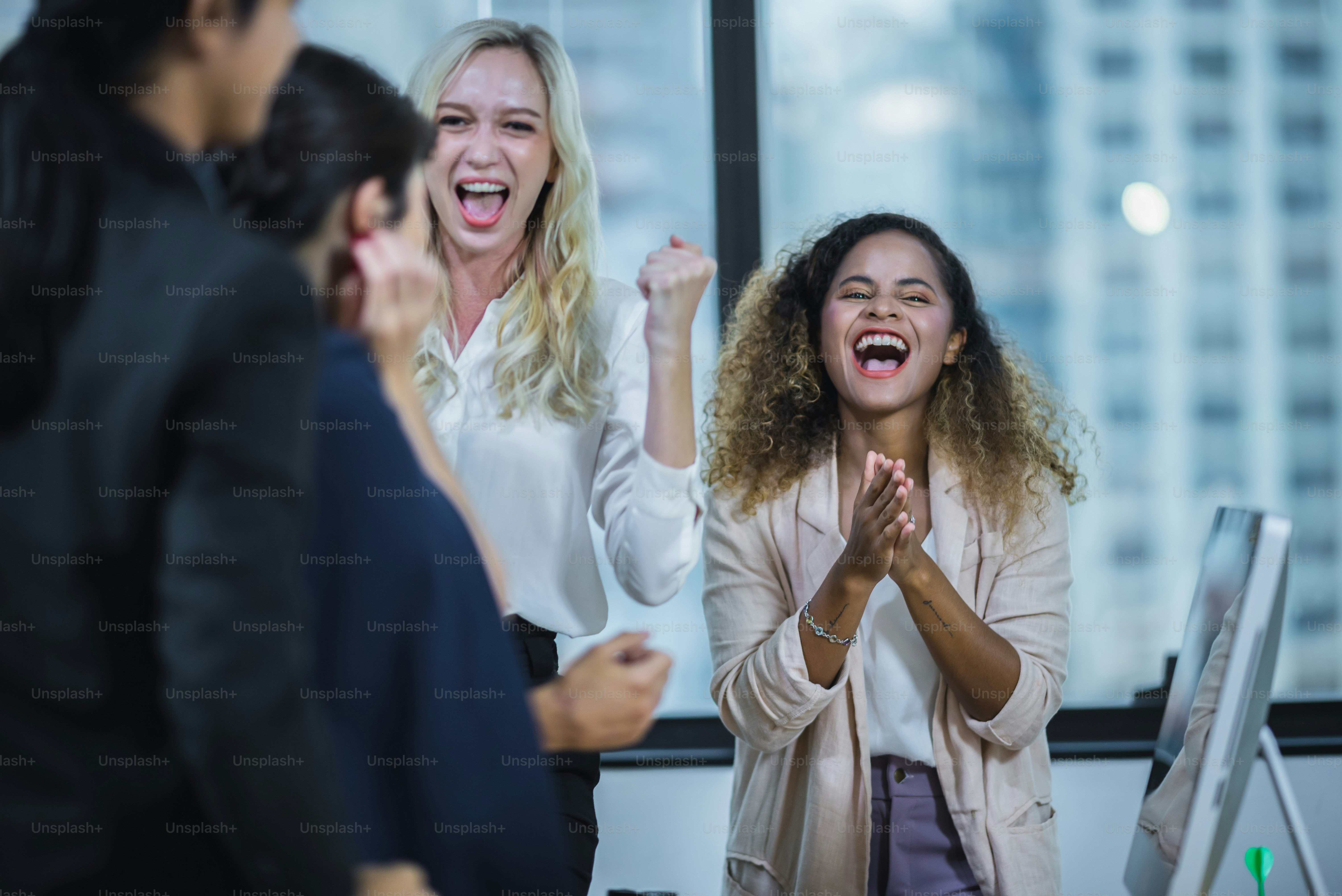 Business staff meeting. Group of young modern people in smart casual wear discussing something while working in the creative office