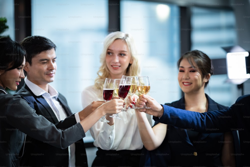 Toast to success. Group of business people toasting with champagne and smiling while standing close to each