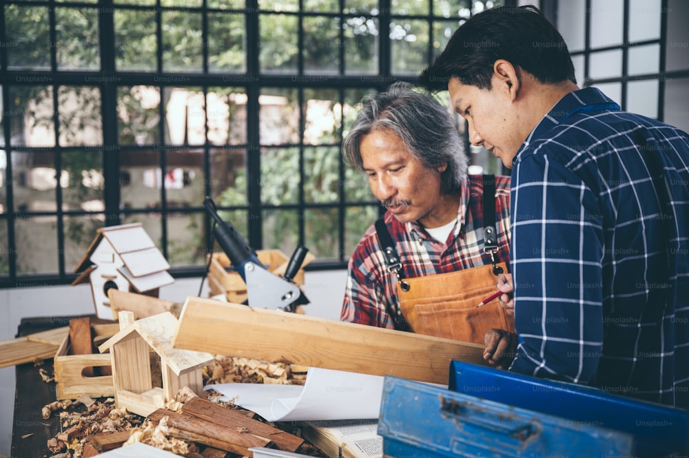 Two carpenters working in shop  wood craftsman
