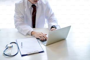 Young male doctor asian working with laptop in the office