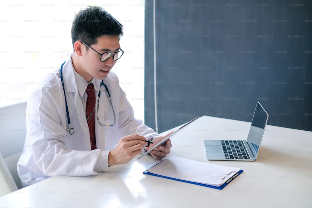 Young male doctor asian working with laptop in the office