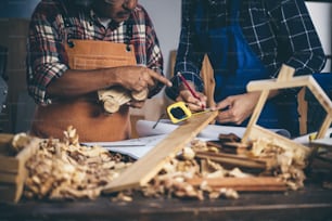 Background image of woodworking workshop: carpenters work table with different tools and wood cutting stand, vintage filter image