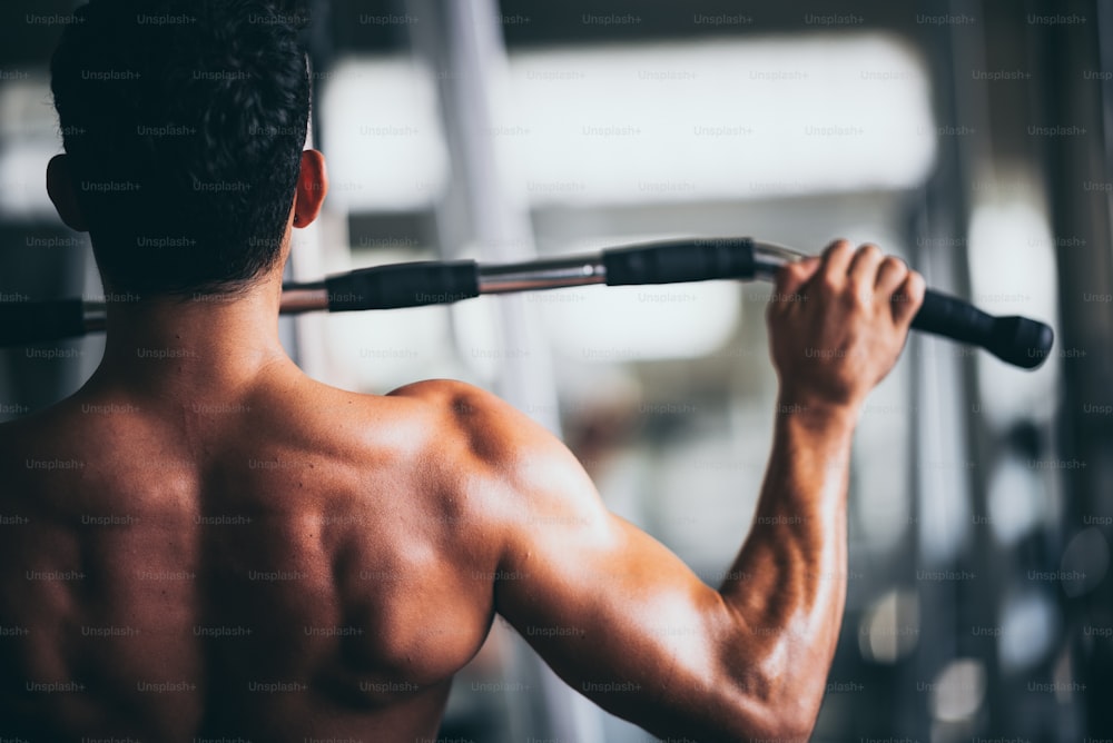 Muscular bodybuilder guy showing in gym