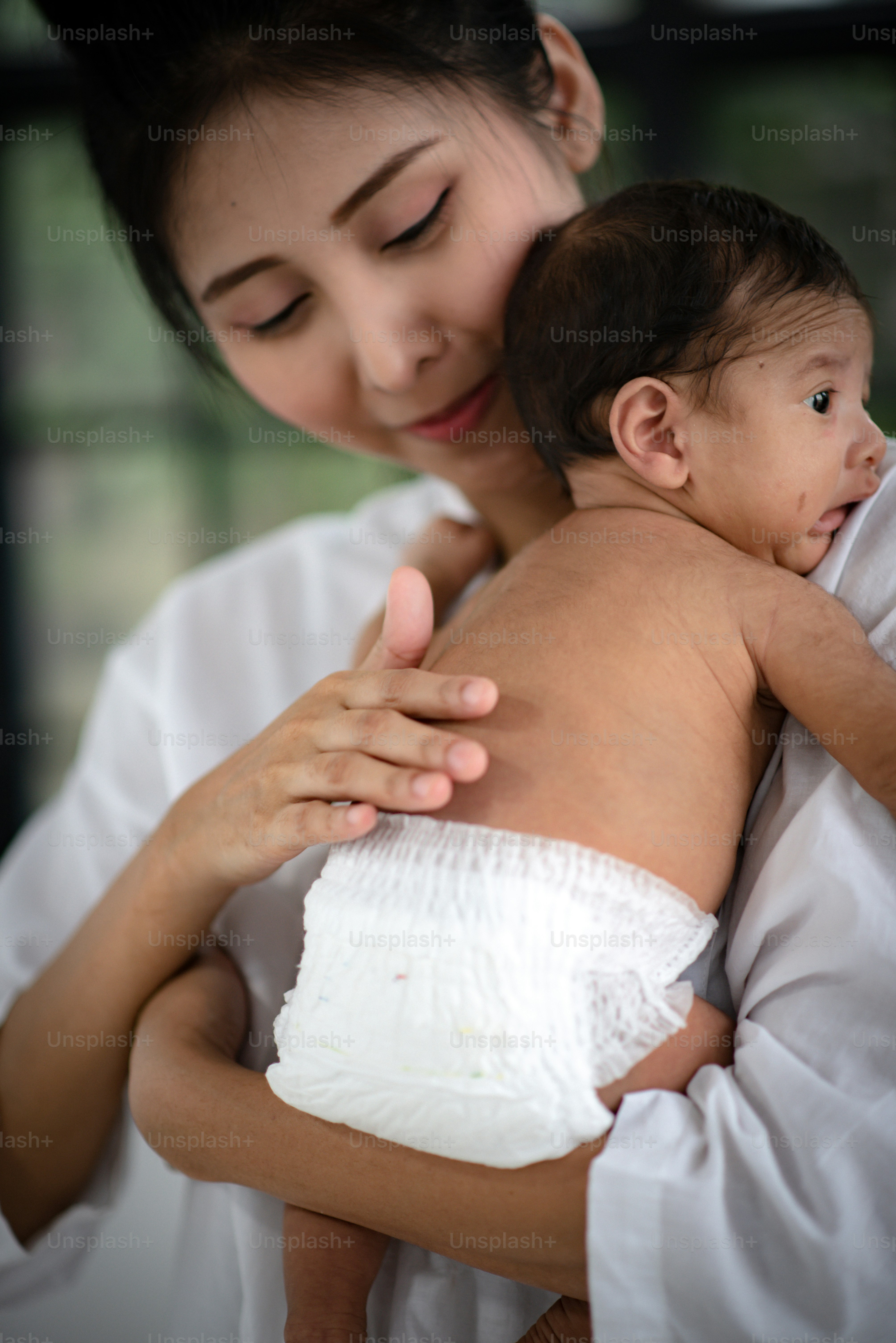 Mother is hugging and showing love to baby