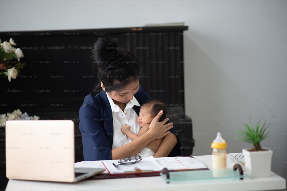 Young business women work while raising babies