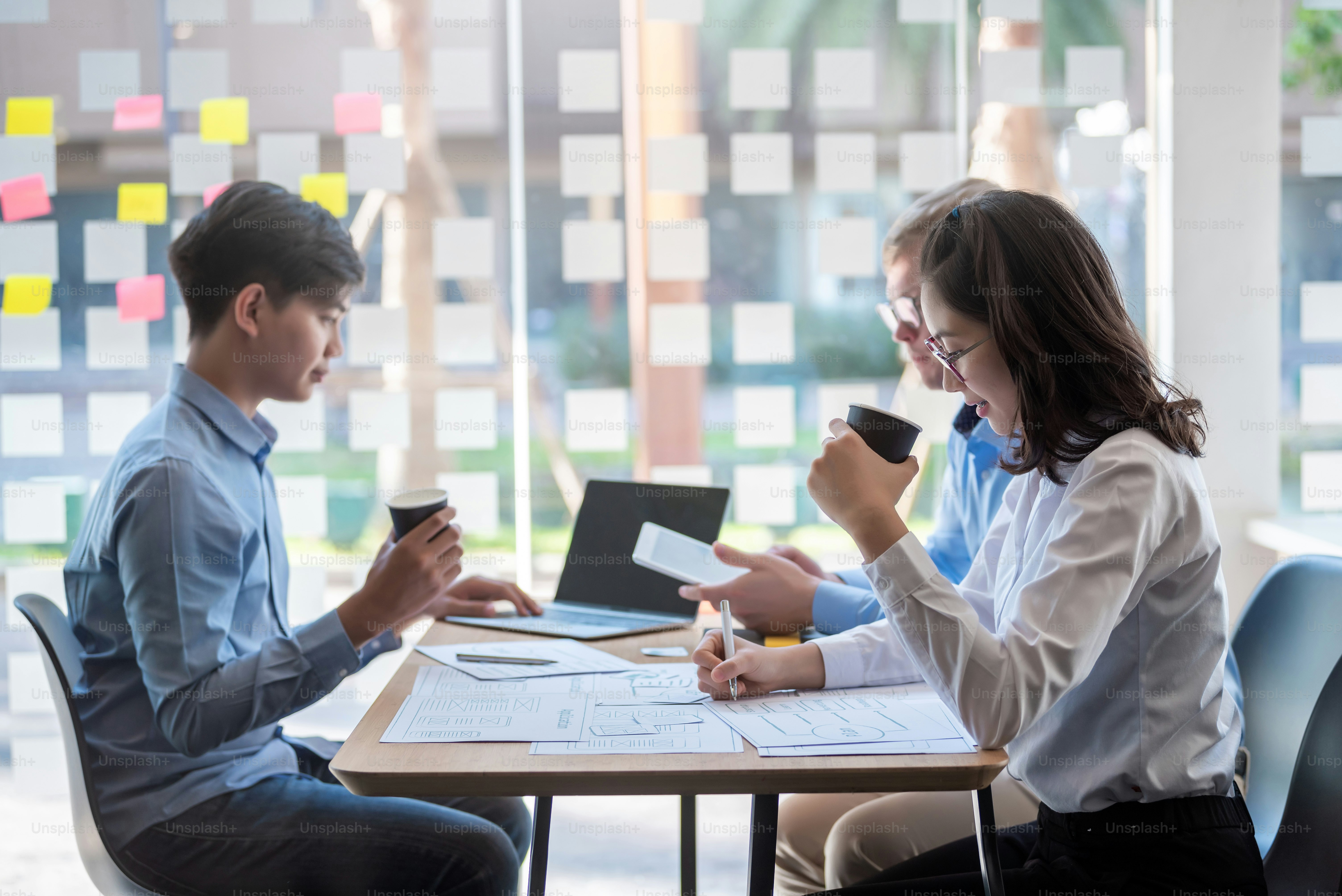 Group of young asian business people working during the presentation talking about business project.