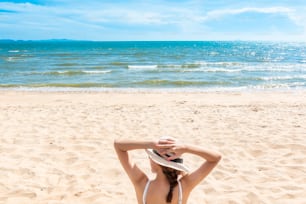 Beautiful woman is sitting on beach