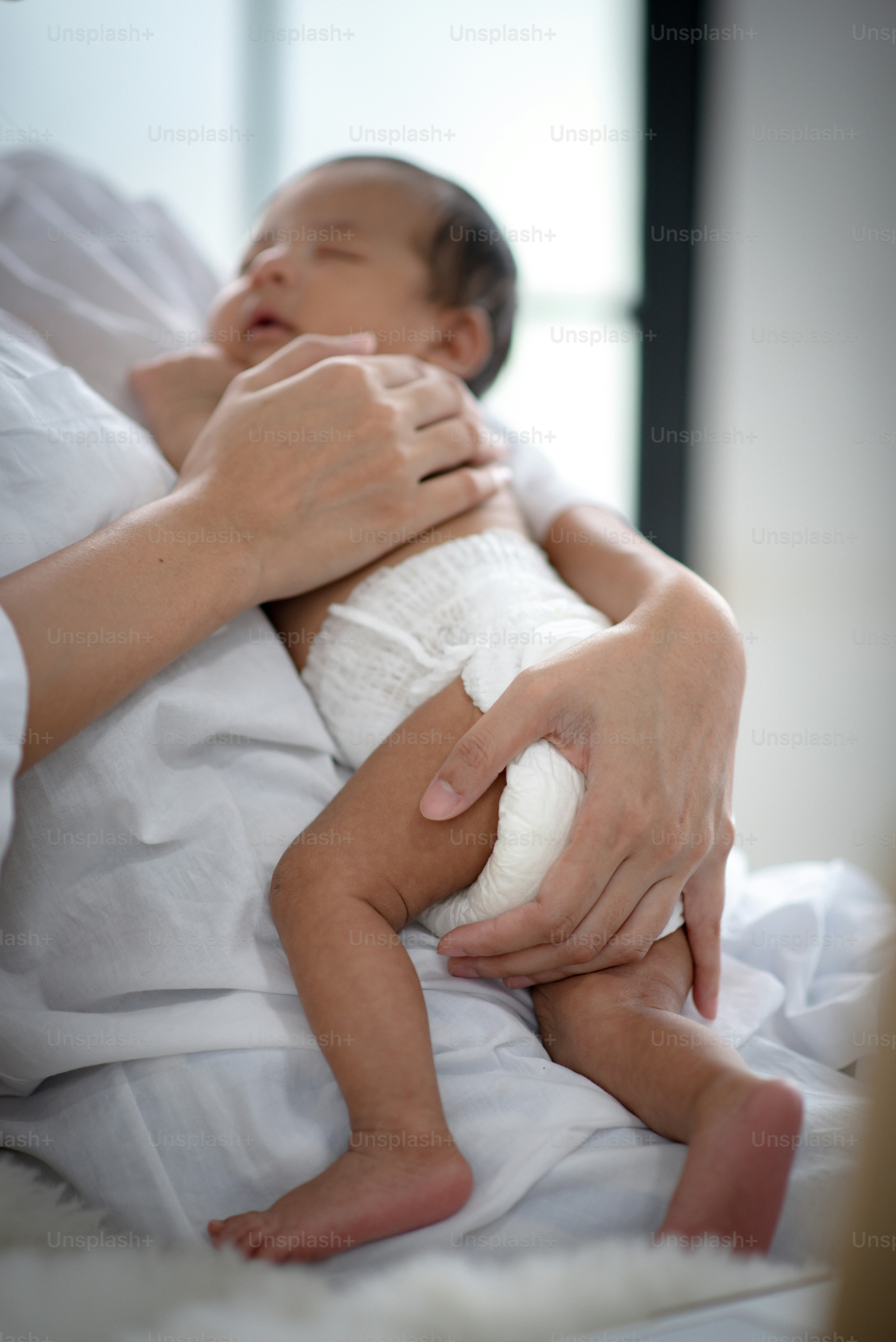 The baby is sleeping on a soft mattress