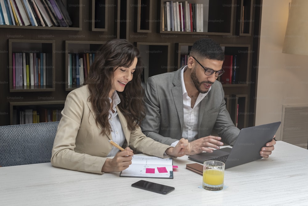A business couple working together with a laptop.