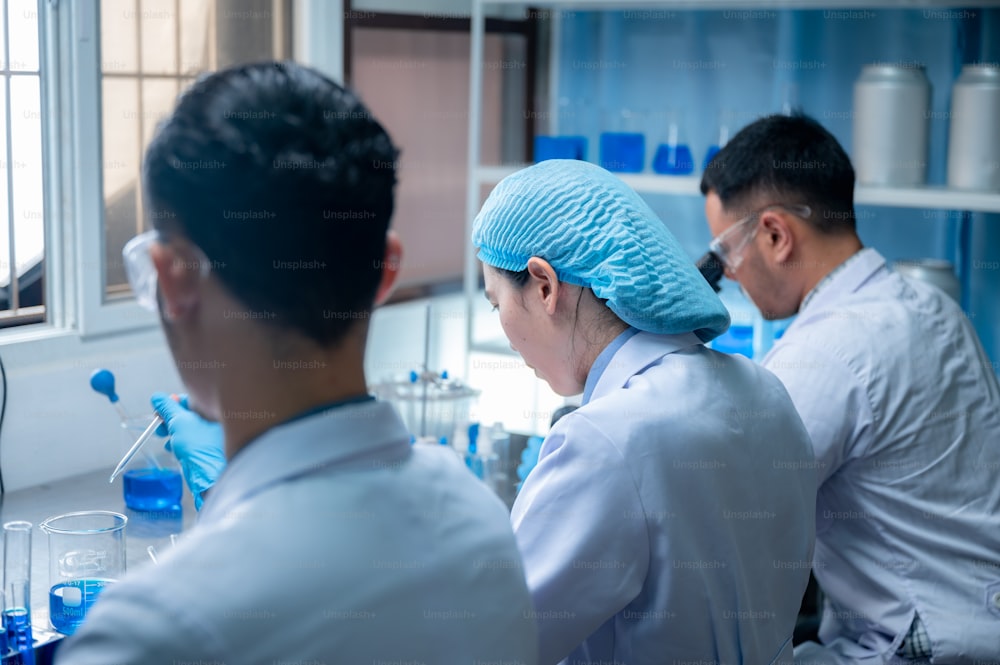 Science and medicine, scientist analyzing and dropping a sample into a glassware, experiments containing chemical liquid in laboratory on glassware, DNA structure, innovative and technology.