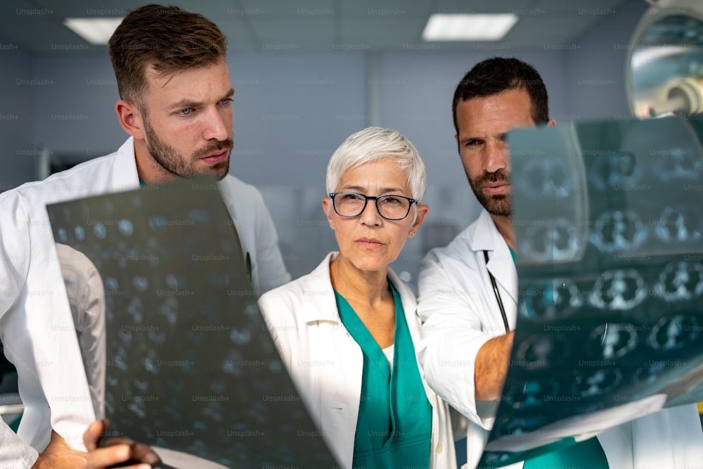 Group of doctor looking at ct, mri scan at hospital to make diagnosis