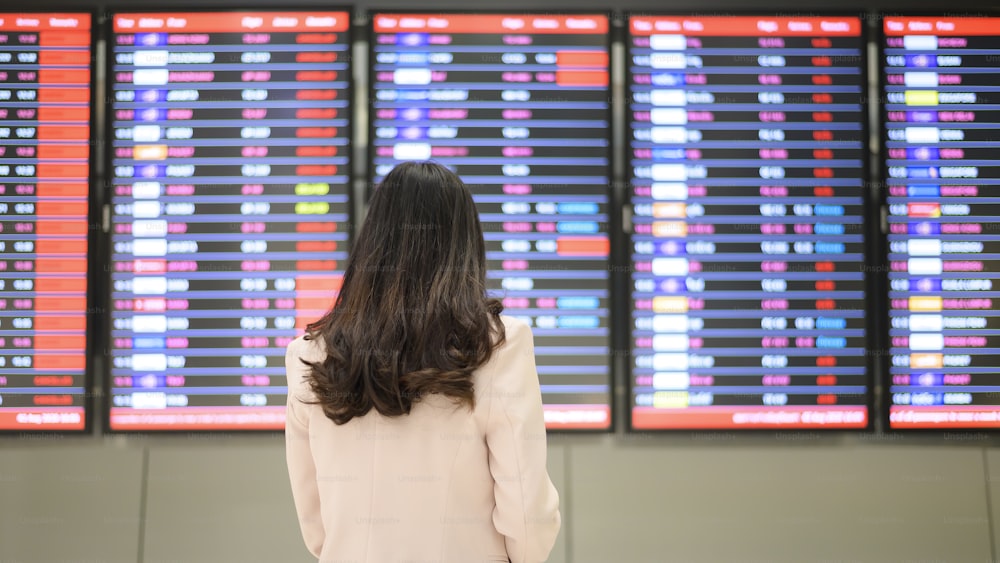 Uma empresária está usando máscara de proteção no aeroporto internacional, viajando sob a pandemia de Covid-19, viagens de segurança, protocolo de distanciamento social, novo conceito de viagem normal.