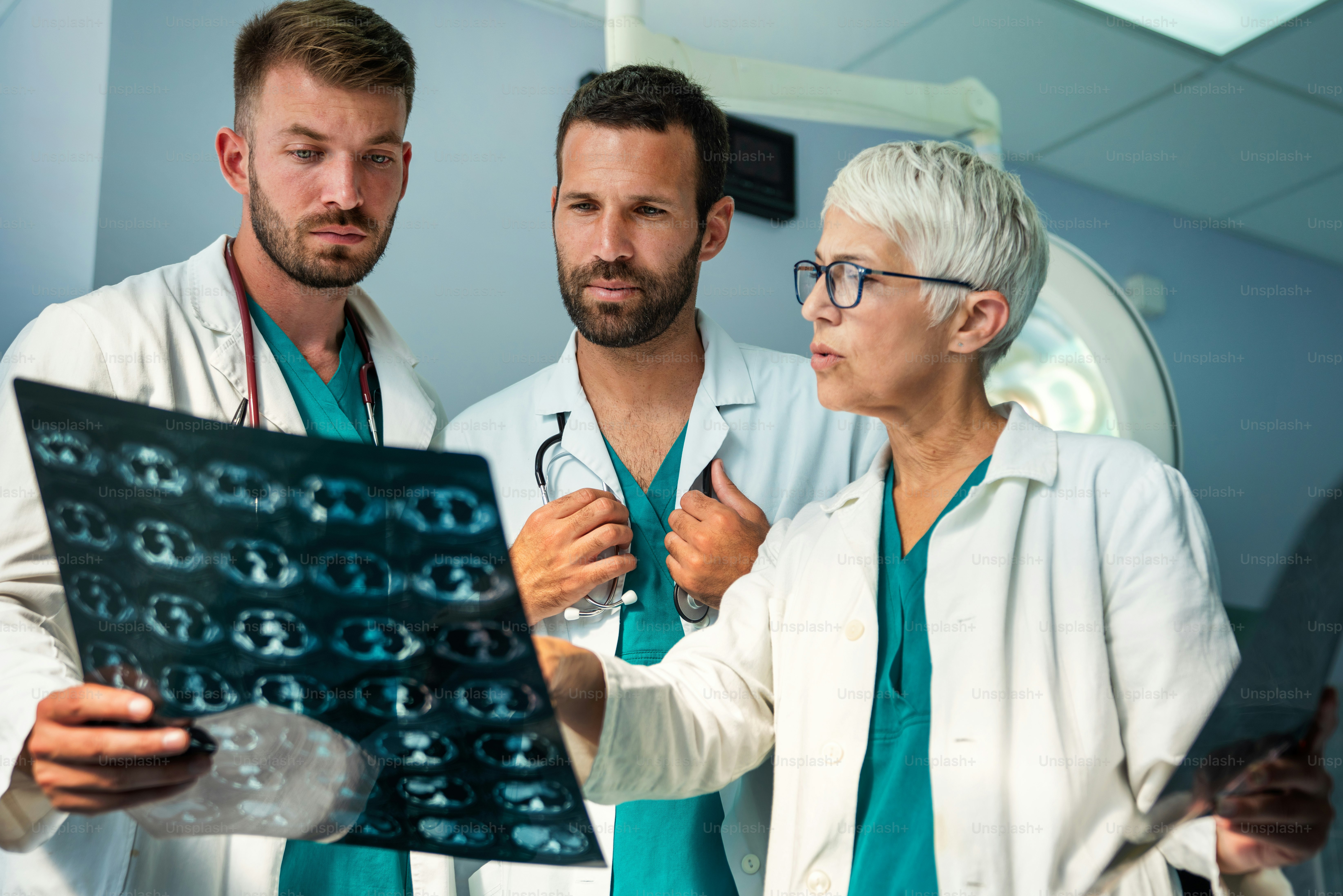 Radiology, health care, people, surgery and medicine concept. Group of doctors looking at x-ray scan image