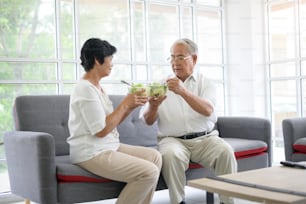 An elderly couple are eating healthy food , grandparents health care concept .