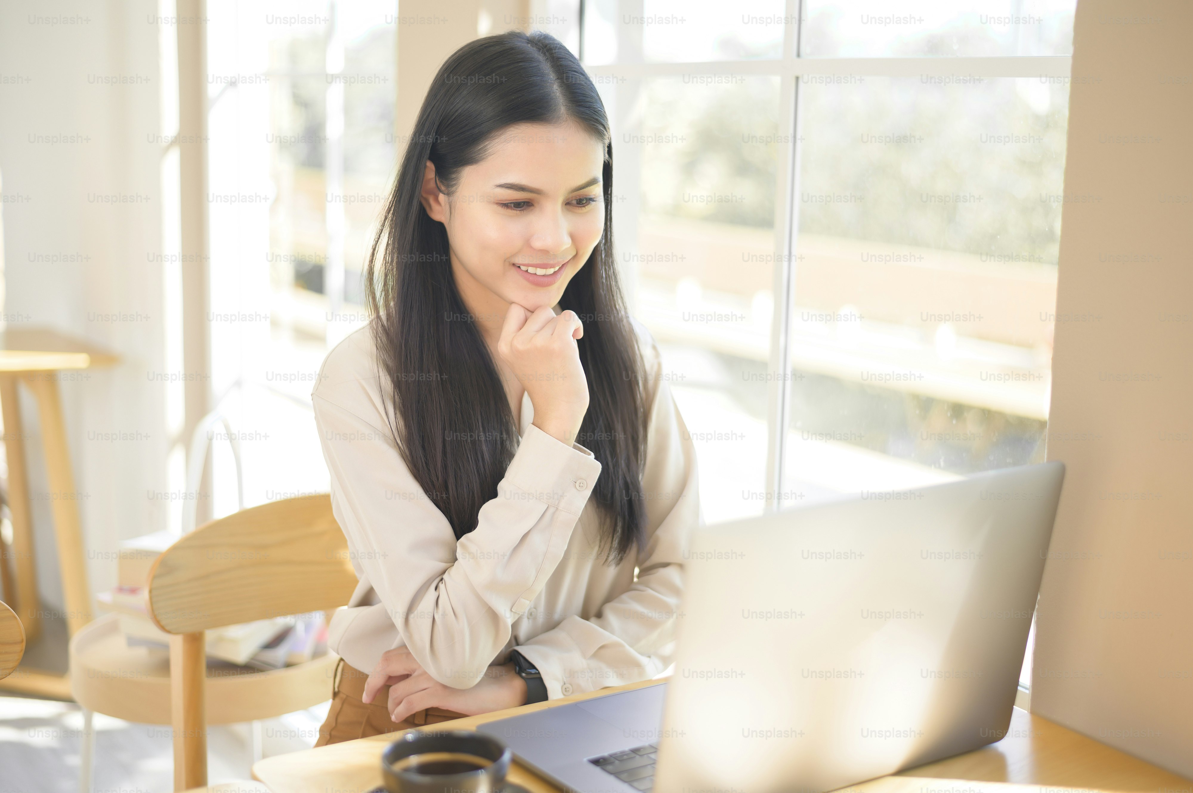 A young business woman working with her laptop in coffee shop