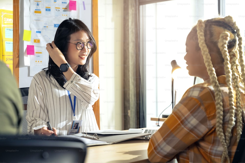 Ux ui desiner female Woman during job interview and three startup founders members of smart tech startup company recruitment manager in modern office workspace