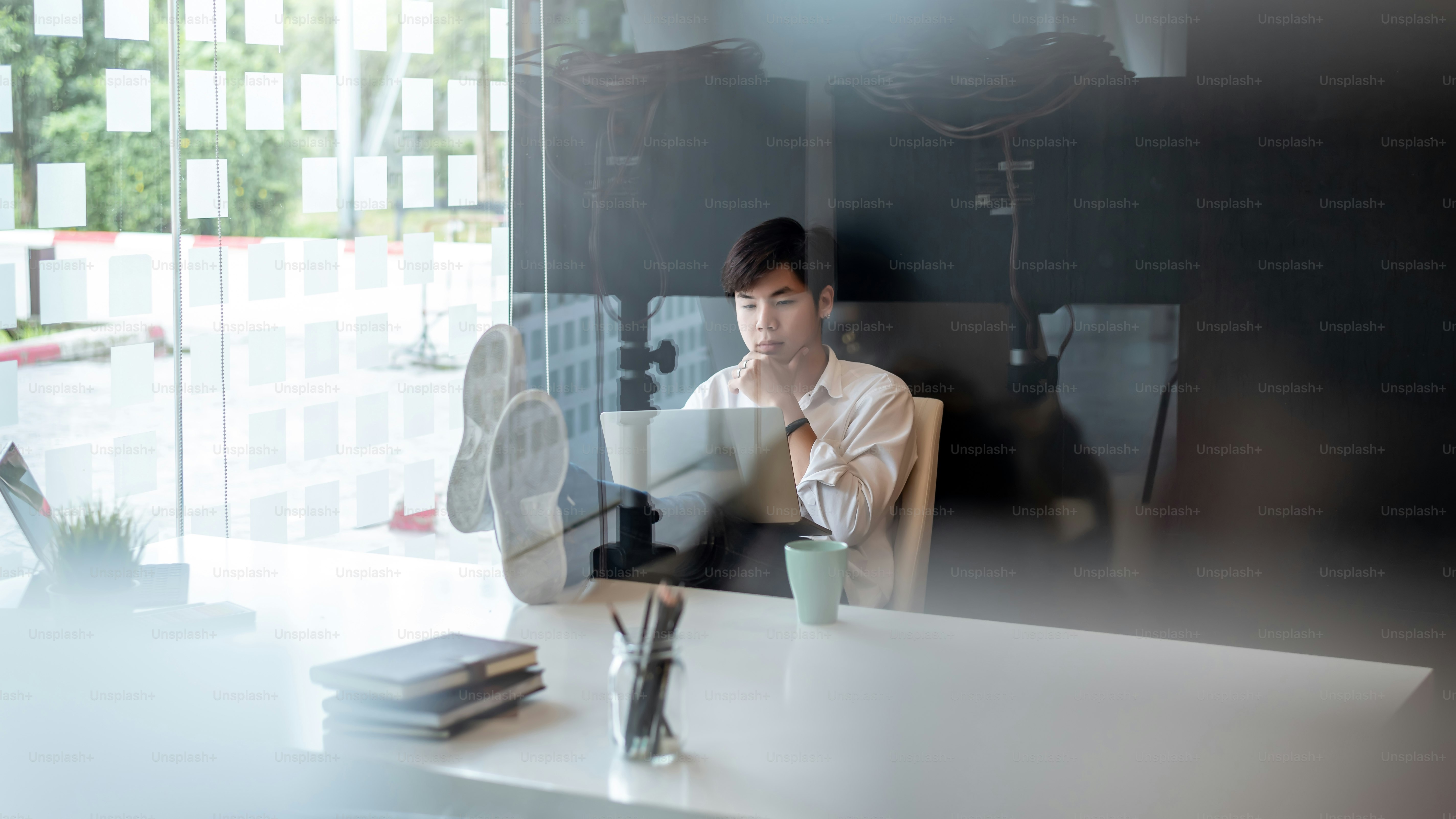 person deeply focused working at desk, blurred background, soft light, calm and concentrated mood