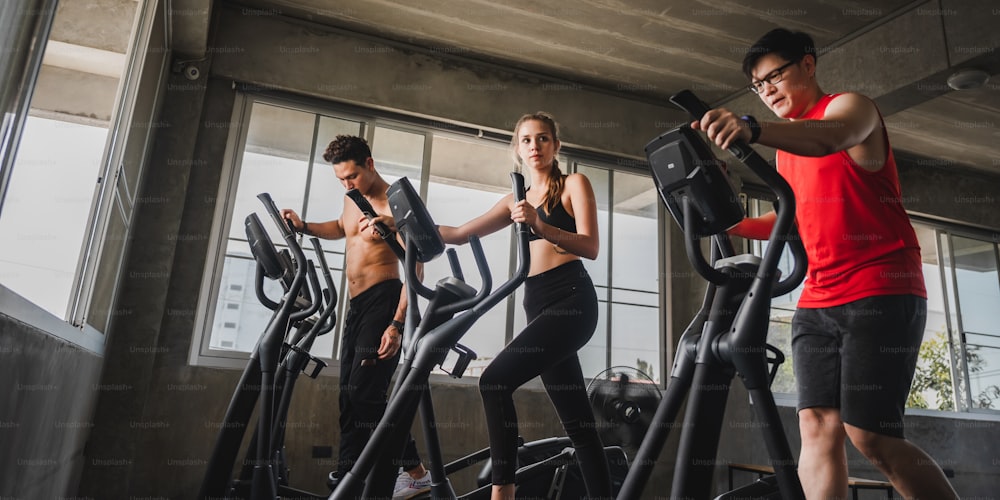 Group of Athletic Sports Running on a Treadmills at fitness club for wellness health. People at gym to build muscle and body strength. Exercise training concept.