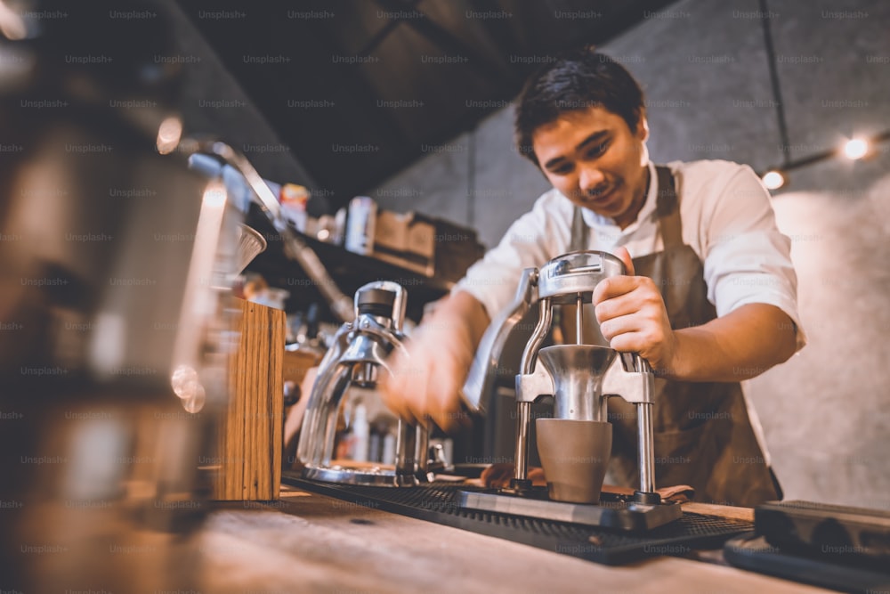 professional barista making hot drink espresso black coffee on vintage wooden table slow bar in cafe, brew caffeine to a glass cup in the morning, filter drip beverage coffee style, hipster lifestyle