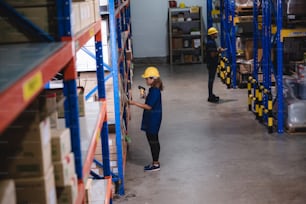 African American worker in warehouse, woman manager checking the store stock, business industry storage report working in warehouse, logistic online shipping service concept