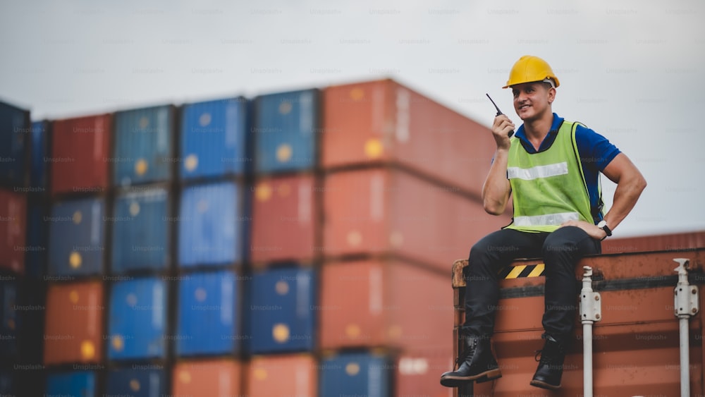engineer foreman working in container terminal in term of industry logistic cargo shipping to export and import, warehouse delivery business freight transport, loading control in port with safety