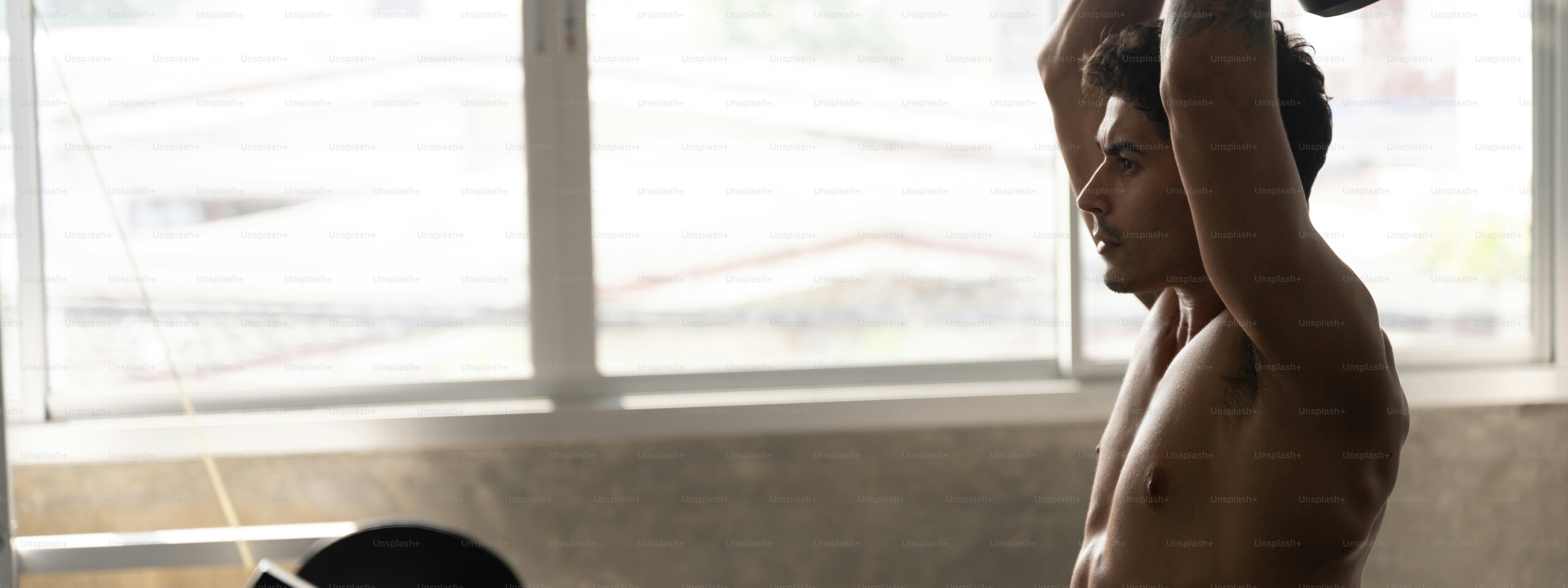 Sportman with dumbbell in hand at professional gym fitness club to build  strong back muscle for  wellness physical