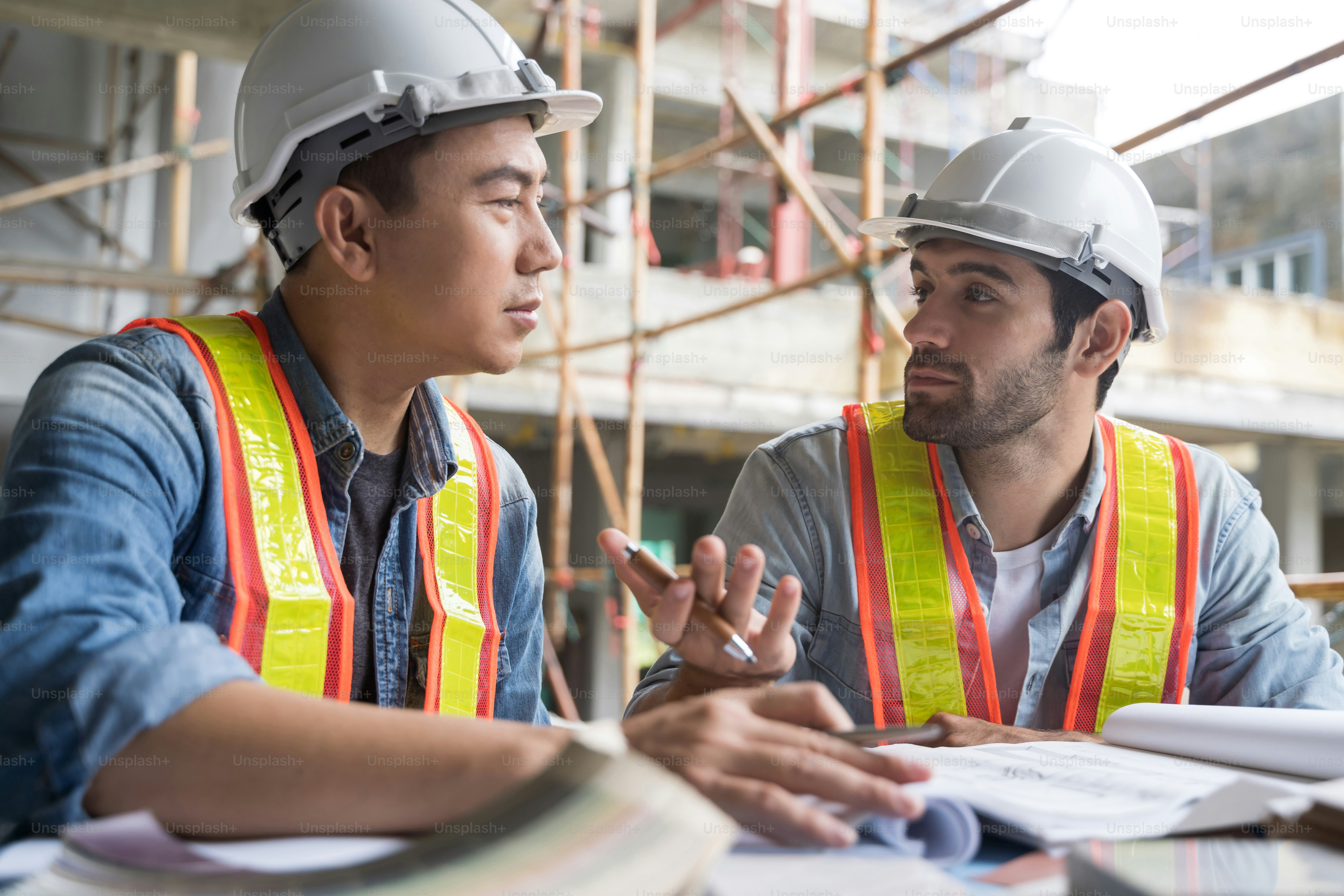 Engineering team working at building site meeting and discussing on ...