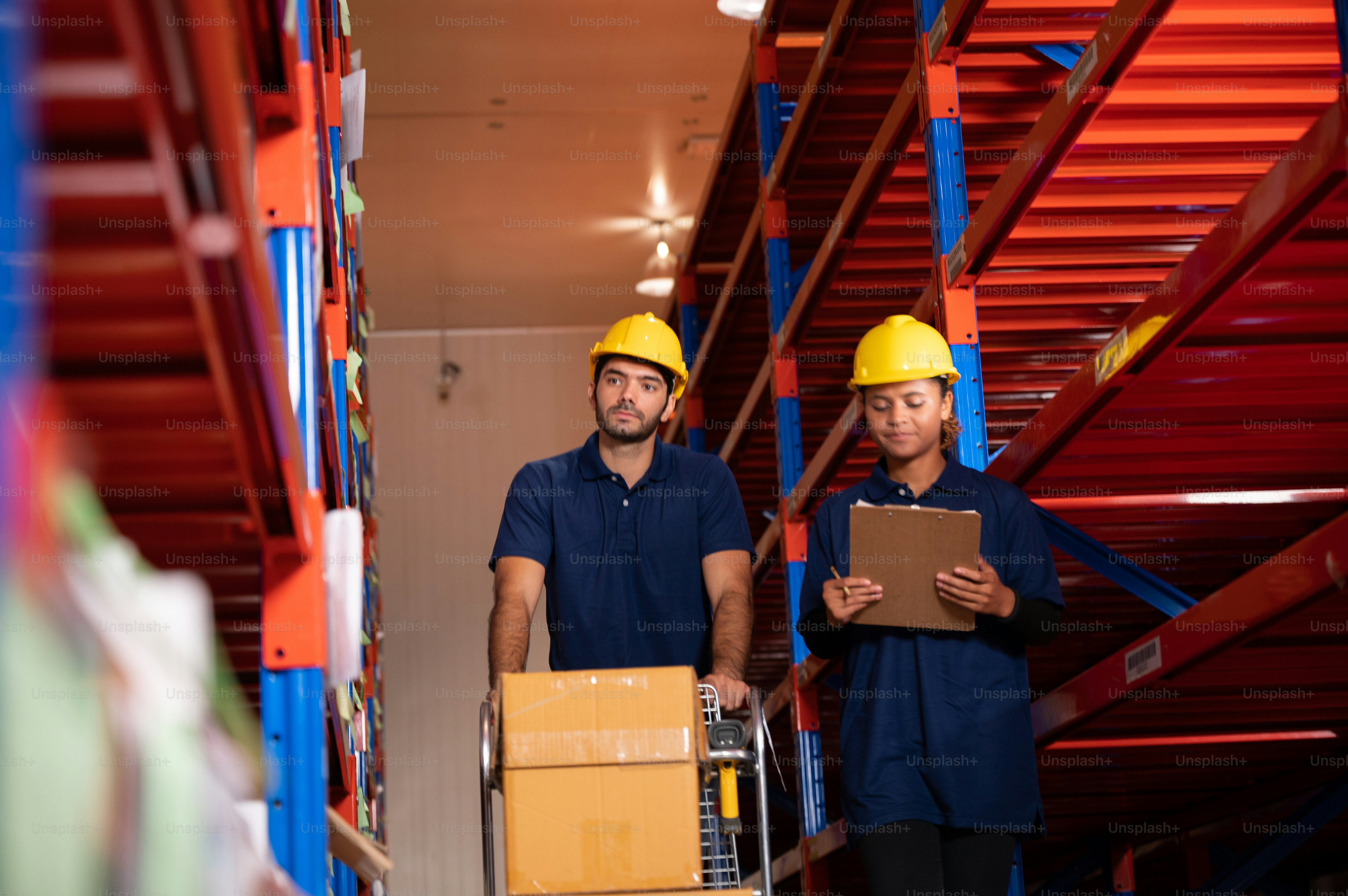 Foreman teamworker men and women work together in warehouse wearing ...