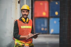 engineer foreman working in container terminal in term of industry logistic cargo shipping to export and import, warehouse delivery business freight transport, loading control in port with safety