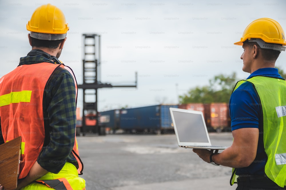 worker teamwork and partner of foreman, engineer, and businessman working in an international shipping area, concept of business industrial and working in container yard"t