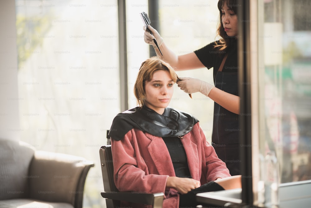 professional hairdresser stylist person and hair fashion beauty salon concept, woman client about haircut and hair care, coiffure barber equipment, hairstylist work to making hairstyle to woman model