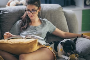 young girl playing a dog at home, cute woman person with her pet animal living from home, female are happy in lifestyle to relaxation to playing with puppy dog, stay home animal lover concept