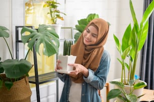 A happy young muslim woman enjoying  and relaxing leisure activity in garden at home