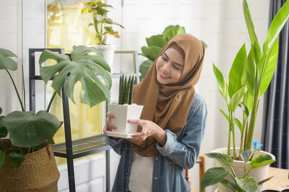 A happy young muslim woman enjoying  and relaxing leisure activity in garden at home