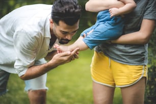 family person concept, father and baby child joy playing in the outdoor nature grass flower garden, having fun and happy smiling, childhood and parent love together in summer at home Father"u2019s Day