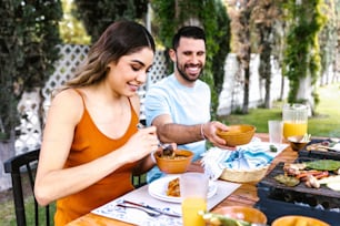 hispanic couple eating tacos and mexican food at outdoor Restaurant terrace in Mexico Latin America