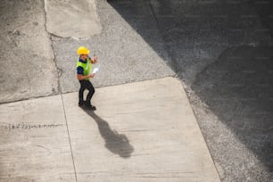 engineer foreman working in container cargo logistic shipping industry for import and export transport, freight business at warehouse port terminal, truck loading control at storage