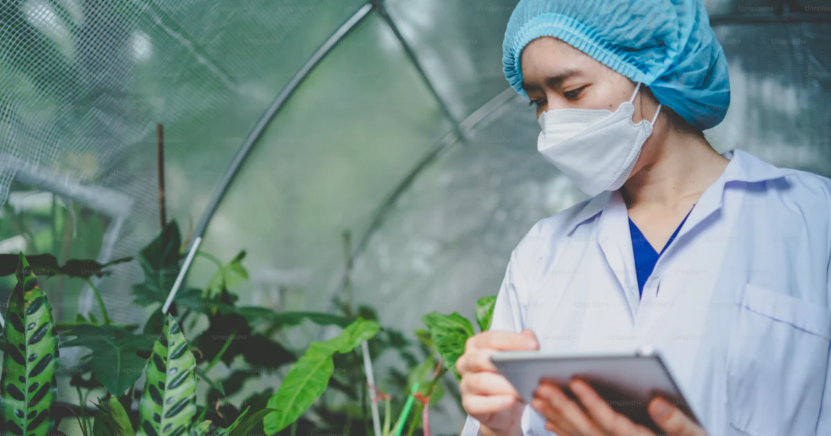 Botanical Key Worker Woman botanist working in greenhouse for gardening a agriculture plant ...