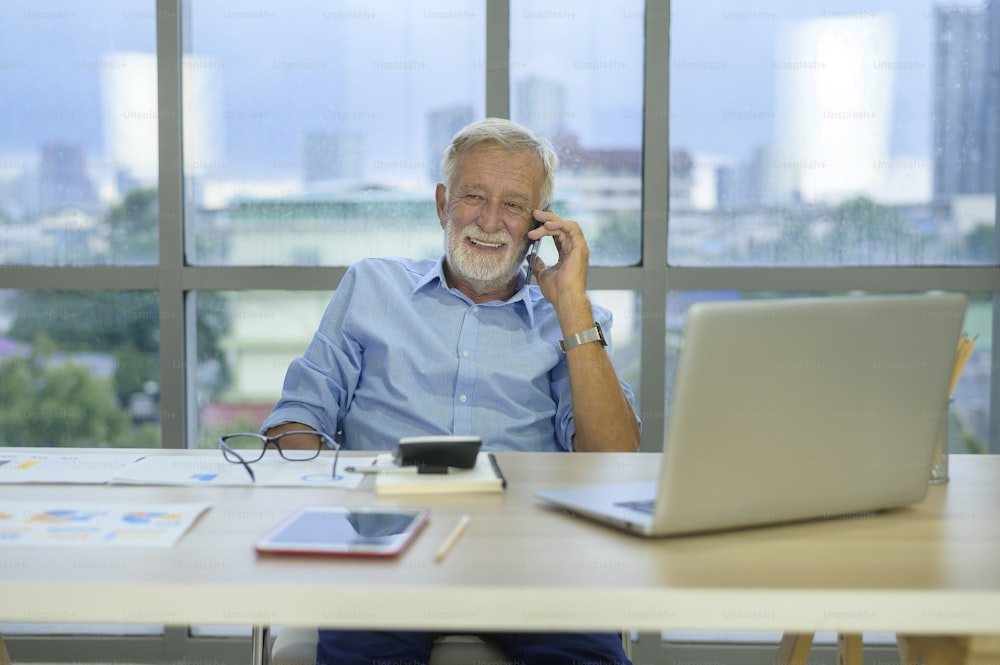 A caucasian senior Businessman working in modern office